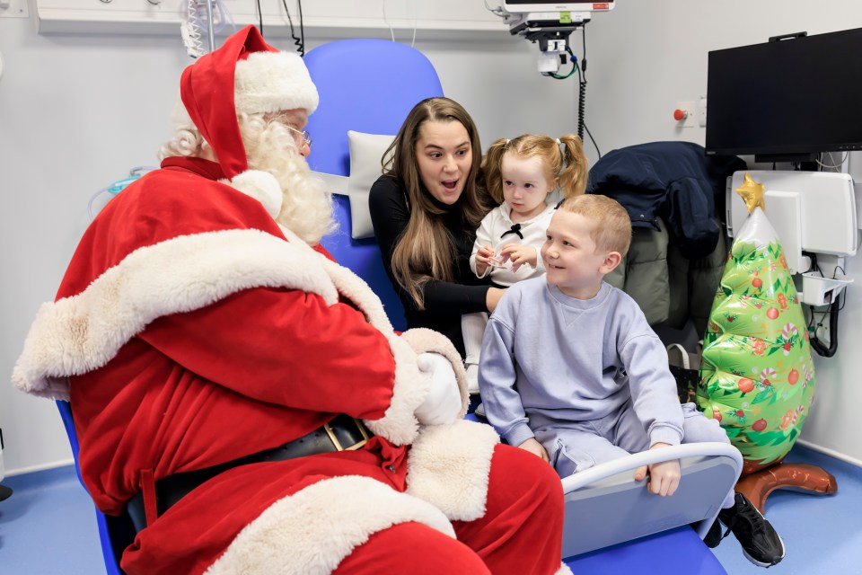 Santa Claus visits children in a hospital's Rainbow Children's Unit.