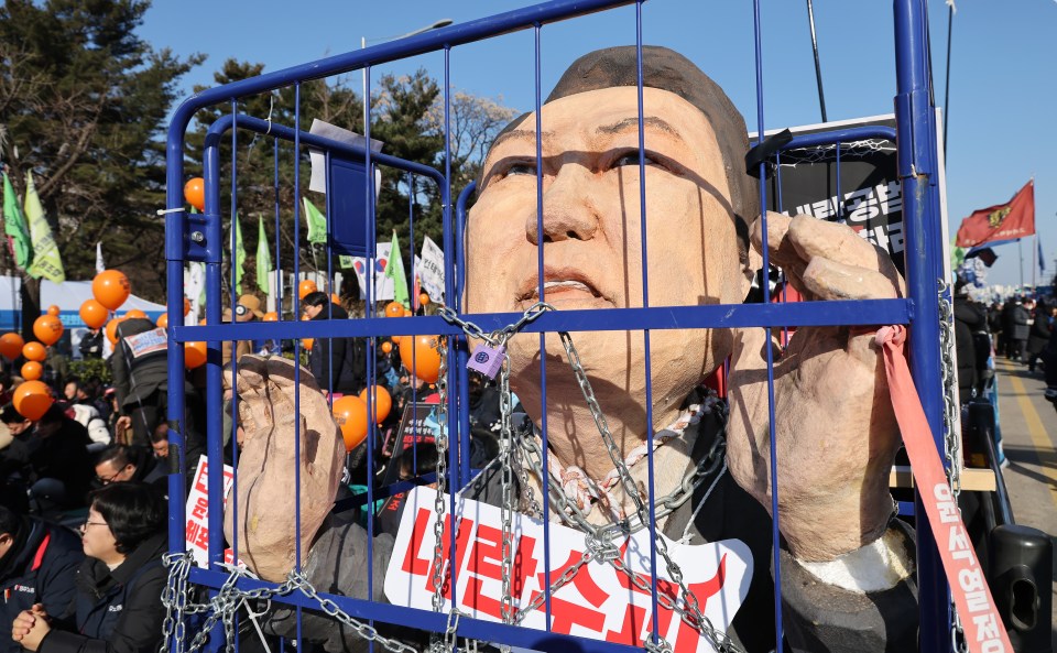 Protesters outside the country's parliament building before President Yoon was impeached