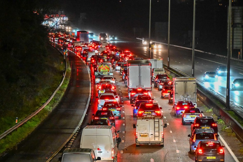 Long queues of traffic at night on a motorway.