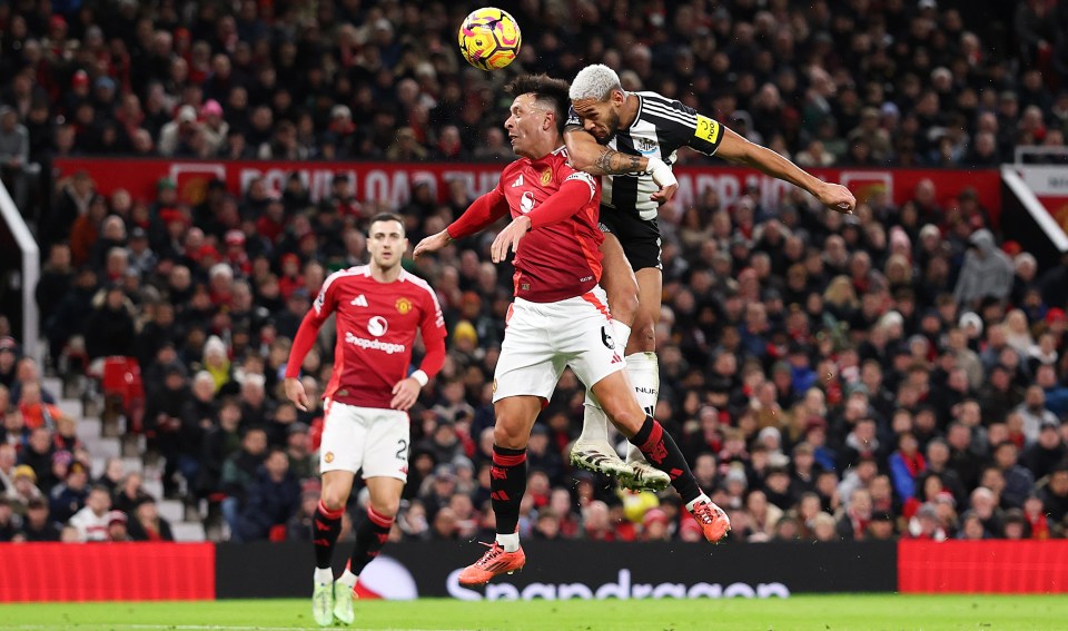 Joelinton of Newcastle United scores a header against Manchester United.