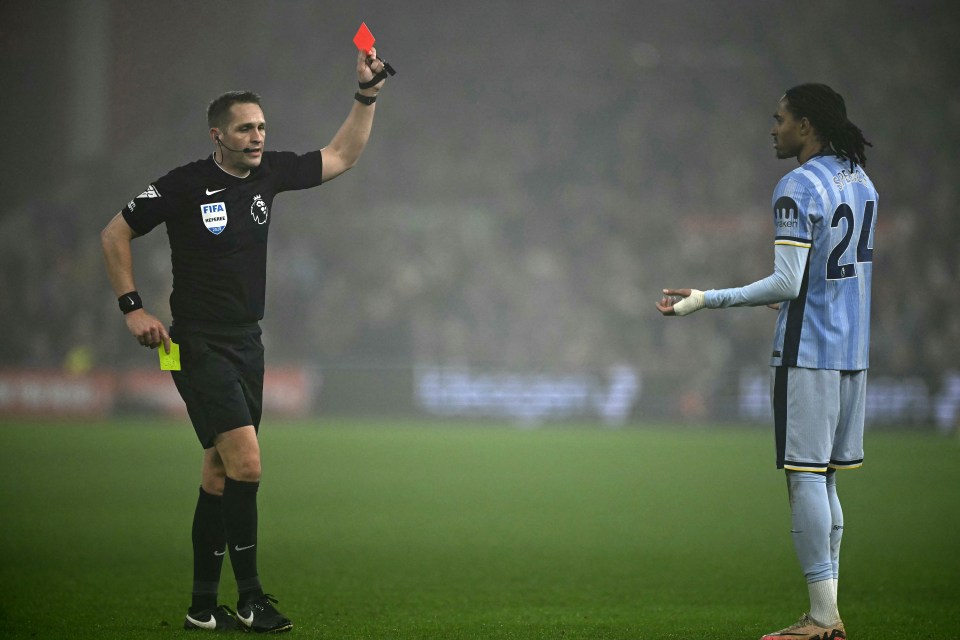 Referee showing Djed Spence a red card.