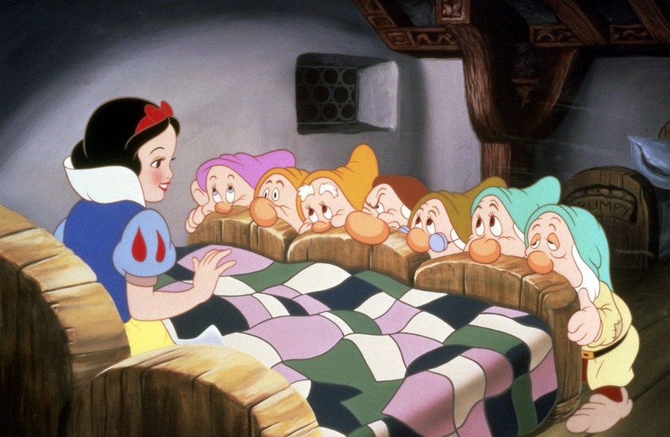 Snow White and the Seven Dwarfs in their cottage.