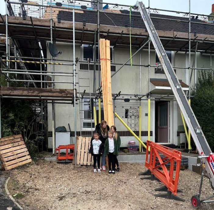 Chantelle Bourne with her three daughters outside their battered home