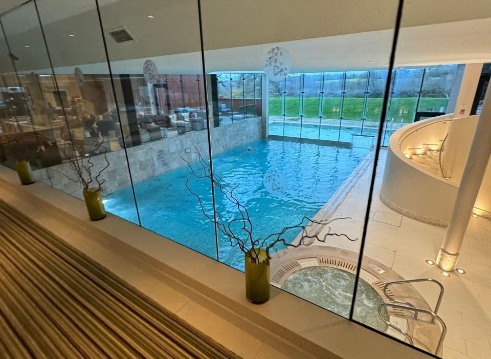 Indoor pool and hot tub viewed from above.