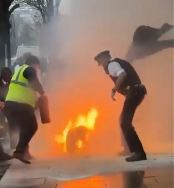 This is the terrifying moment police desperately fought to put out flames on a man after he set himself on fire