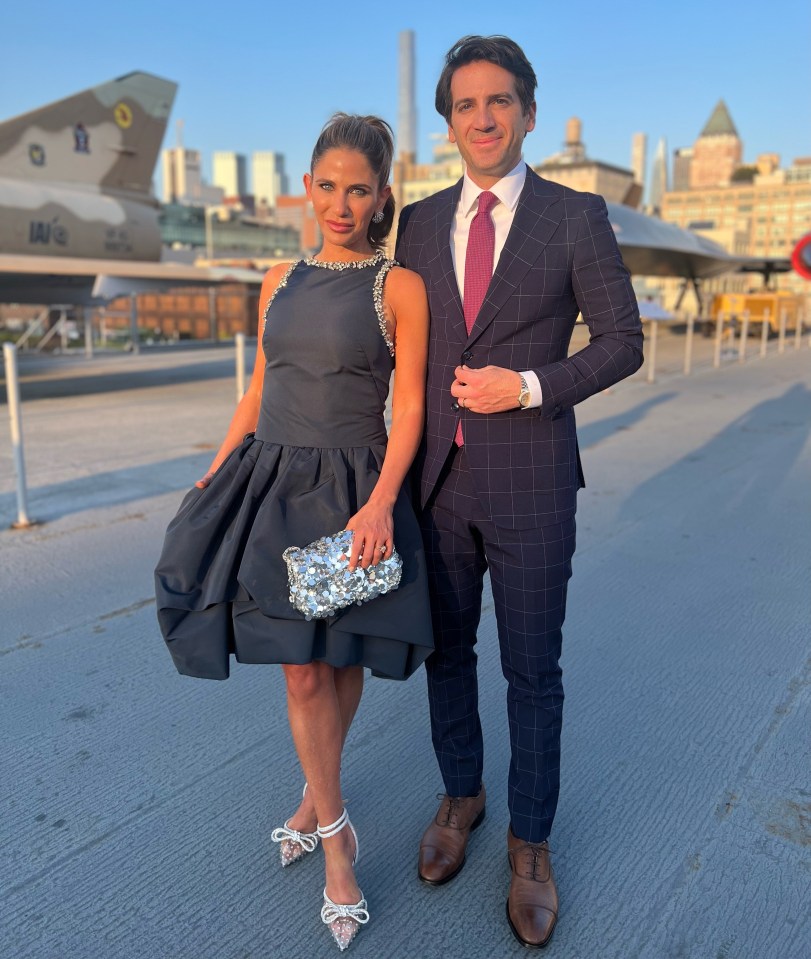 Couple in formal wear standing outdoors.