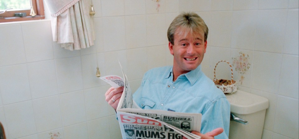 Norvelle reading The Sun at his home