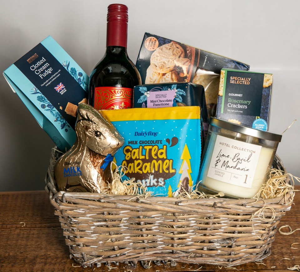 Christmas hamper with wine, chocolates, biscuits, and crackers.