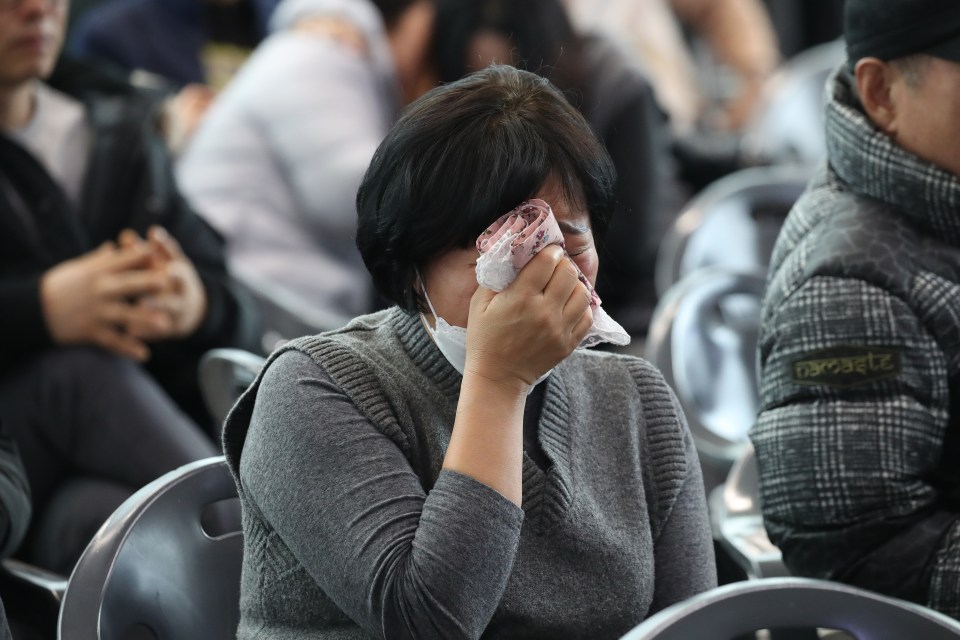 Family members in tears at the airport