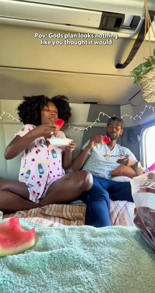 Couple eating watermelon in their lorry.