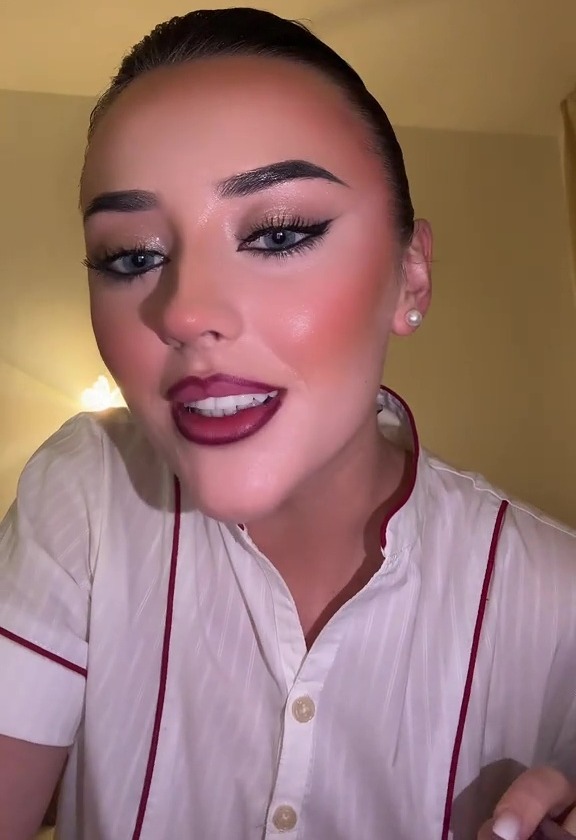 Flight attendant demonstrating her long-lasting red lip makeup.