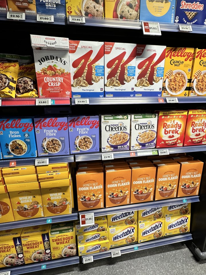 Assortment of breakfast cereals on supermarket shelves.