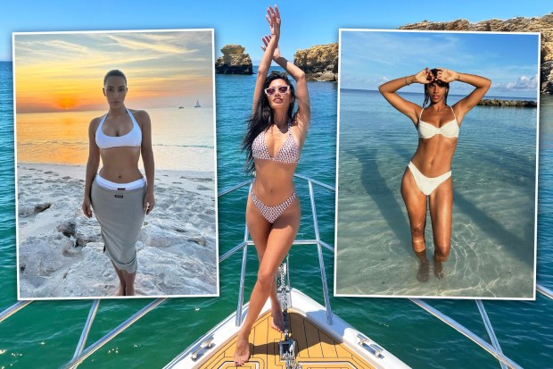 Three women in bikinis on a boat.