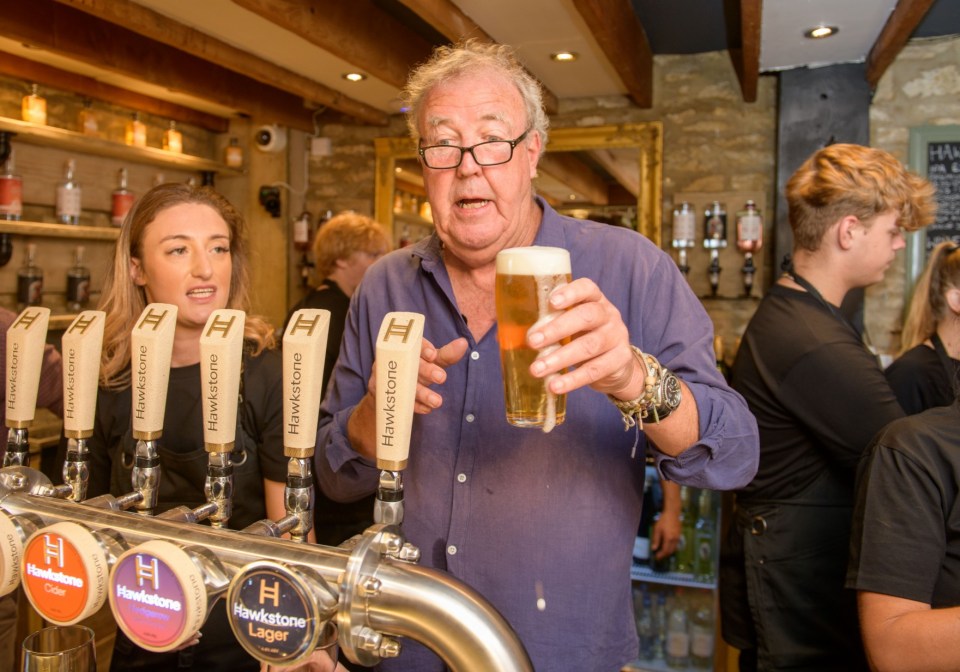 Jeremy Clarkson at the opening of his pub, The Farmer's Dog, holding a pint of beer.