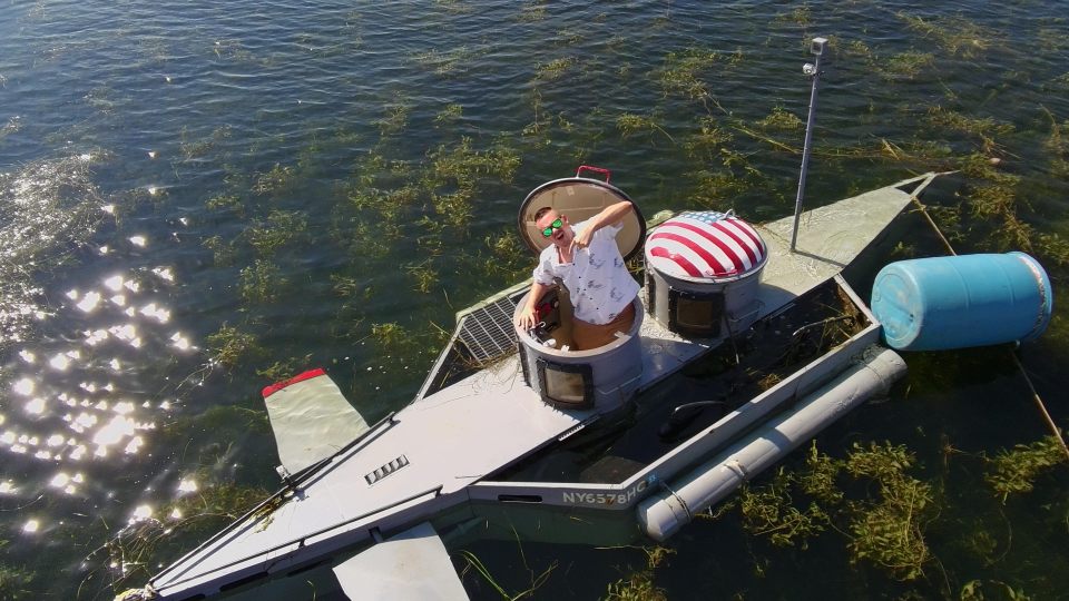 Ariel view of Steve standing in his submarine in the lake