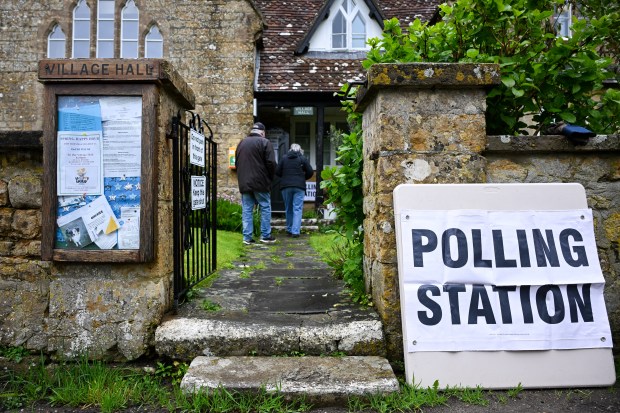 WALDITCH, ENGLAND - MAY 02: People arrive at the village polling station, on May 02, 2024 in Walditch, England. Polls have opened across 107 authorities in England where voters are set to determine the fate of nearly 2,700 council seats. (Photo by Finnbarr Webster/Getty Images)