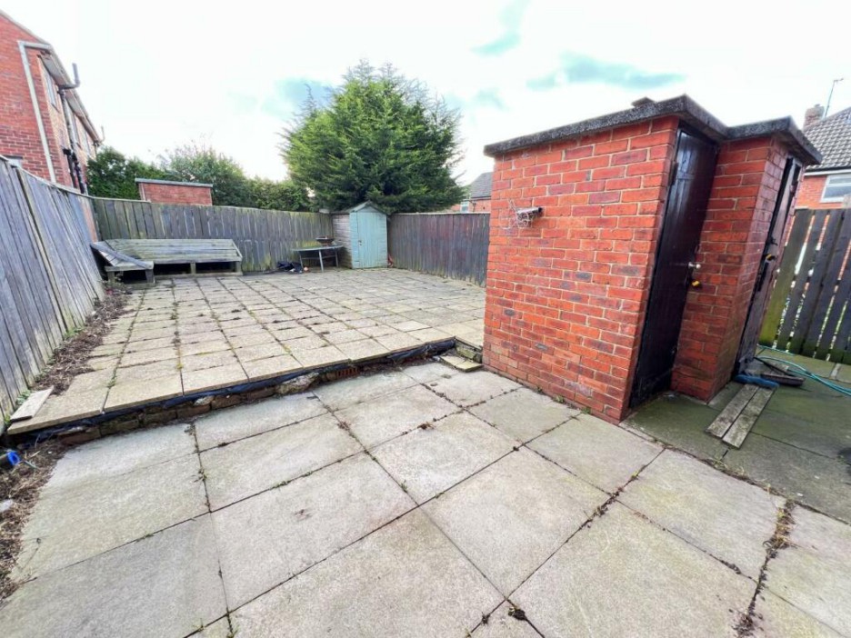 The back garden is paved for low maintenance and has two brick storage sheds