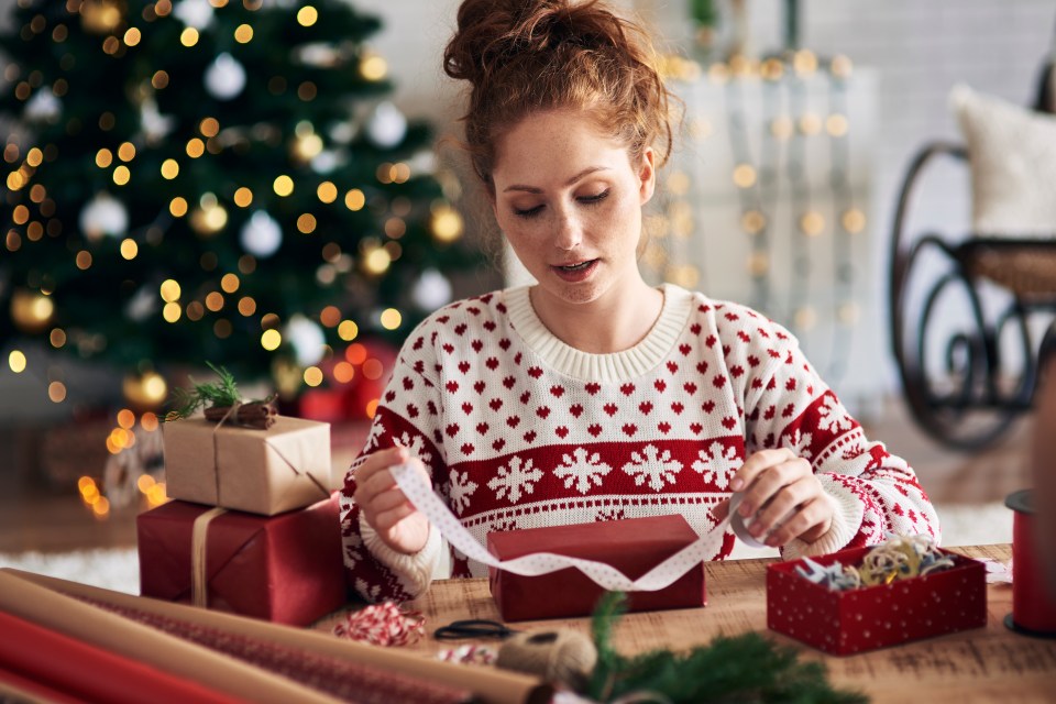 Woman wrapping a Christmas present.