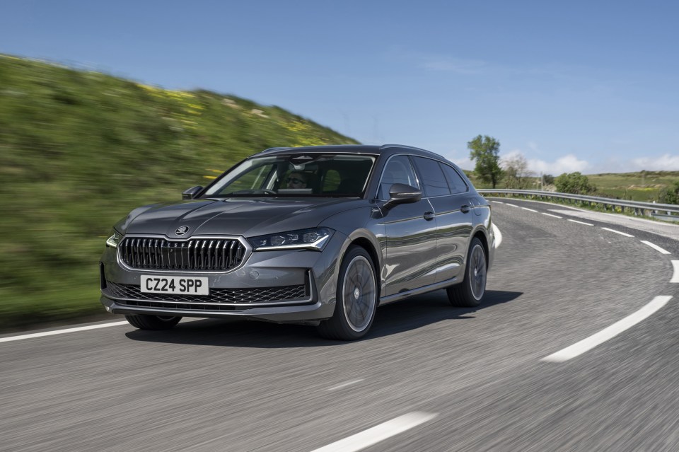 Gray Skoda Superb Combi driving on a road.