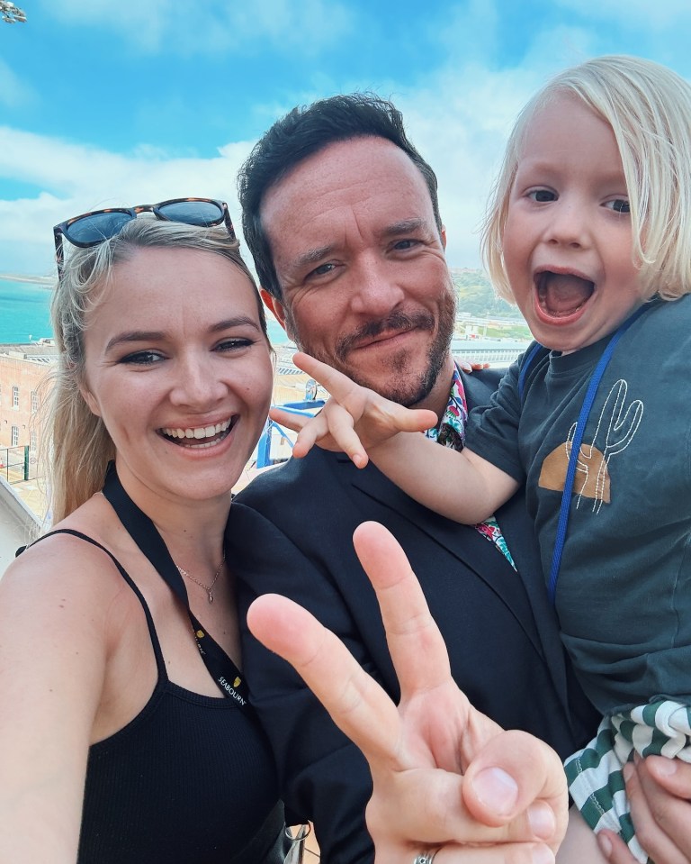 Family selfie with peace sign.