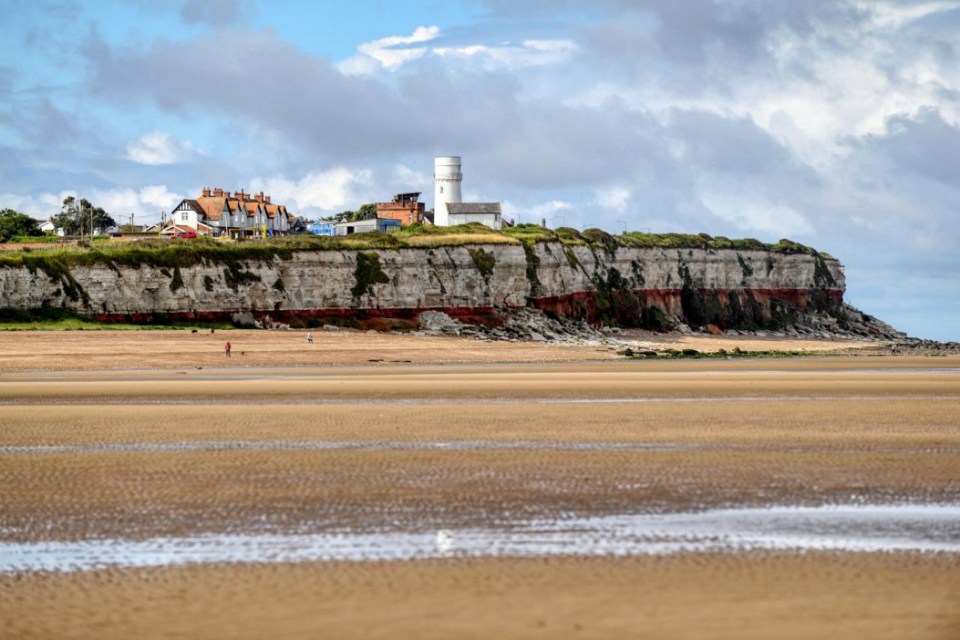 A view across the beach at Old Hunstanton, Norfolk. Release date  November 27, 2024. The future of a huge new home on a Millionaire's row of houses that inspired author PG Wodehouse and sparked a row within a quiet village is set to be decided. Rising tensions over a controversial new home had lead to parish councillors in Old Hunstanton, Norfolk to issue a public warning to villagers. The parish council had received a string of abusive phone calls over The White Cottage which had allegedly been built in breach of planning permission. Mr and Mrs Middleton, owners of the home, are now seeking retrospective planning permission for the new three storey building on Wodehouse Road. The street is named after PG Wodehouse, the author of the Jeeves and Wooster stories, who was a frequent visitor to the village. The property is at the centre of a furious row, with locals and the parish council claiming the "unsightly" building has breached planning conditions. Villagers claimed the property should have been built as a three-storey home, rather than two. The couple from Lincolnshire denied there had been a breach of planning conditions and the house was always approved as a three-storey home. However they admitted there had been 'slight' alterations to the windows and balcony, and an additional basement room.