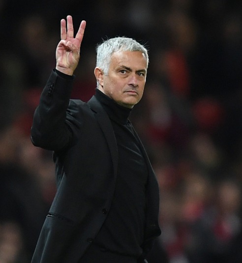 Jose Mourinho gestures to fans to show his three Premier League titles