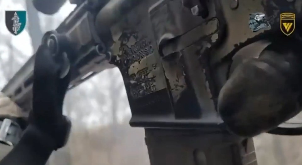 A Ukrainian soldier blasts Russian troops with his assault rifle