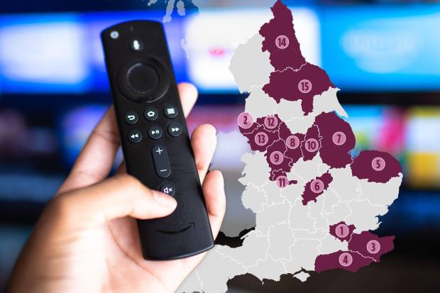 Hand holding a Fire TV remote with a map of the UK highlighting regions.