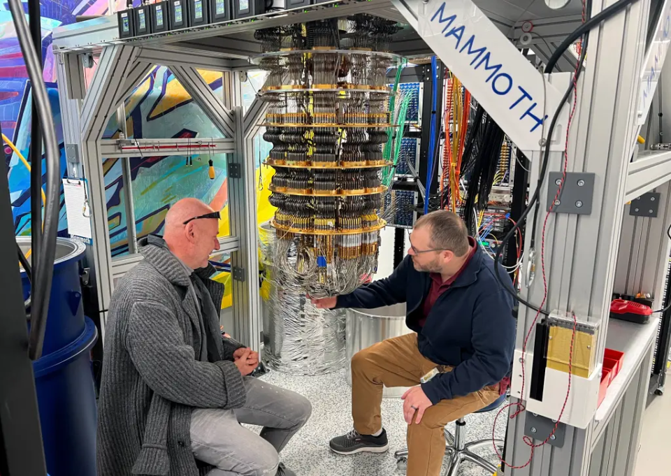 Hartmut Neven (L) and Anthony Megrant (R) examine a cryostat refrigerator