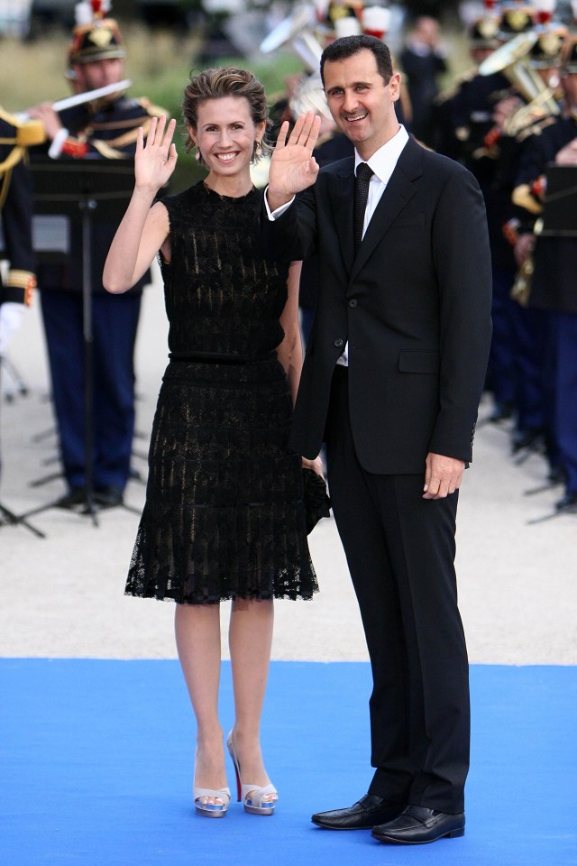 Bashar al-Assad and his wife Asma waving at an official dinner.