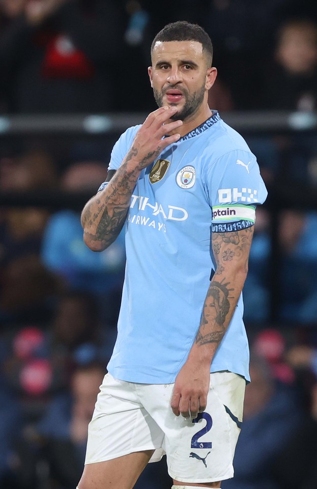 Kyle Walker of Manchester City looking dejected on the field.