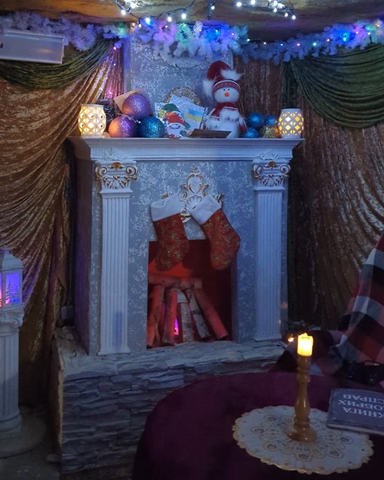 A large replica hearth has been constructed, complete with fake glowing wood and Christmas stockings