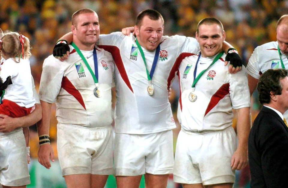 Phil Vickery, Steve Thompson, and Trevor Woodman, England rugby players, with medals after winning the 2003 Rugby World Cup.