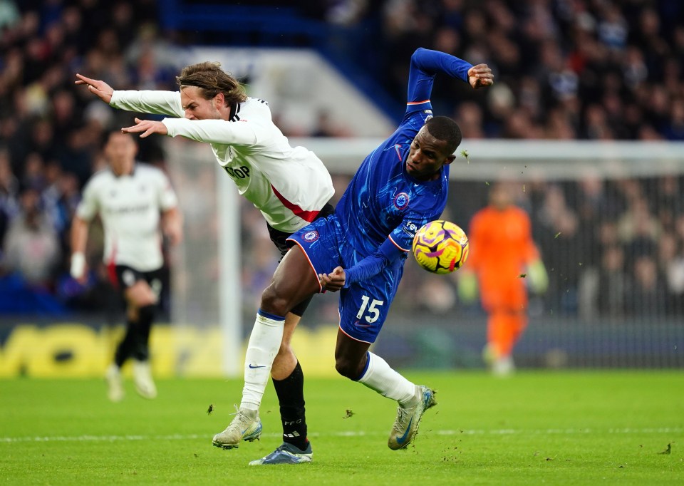 Two soccer players vying for the ball during a Premier League match.