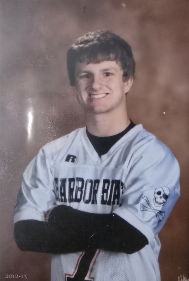 Portrait of a smiling young man in a Harborside lacrosse jersey.