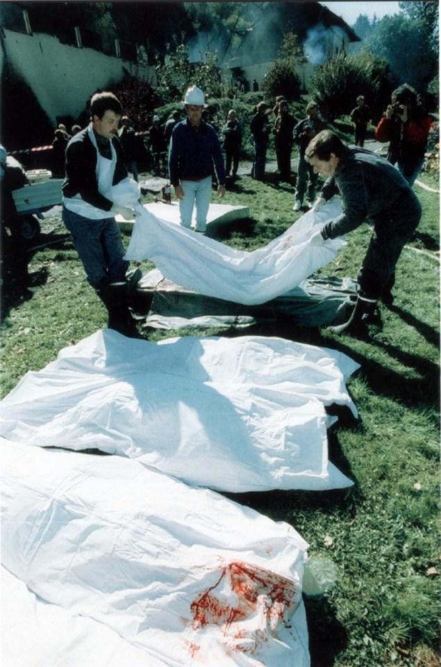 Rescue workers remove bodies from the tragic house fire