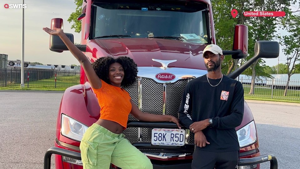 Couple posing in front of their red semi-truck.