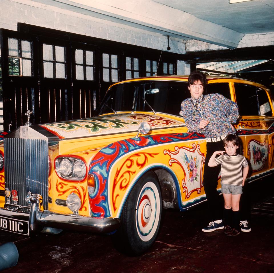 Lennon with son Julian pose by the singer's psychedelic Rolls Royce in 1968