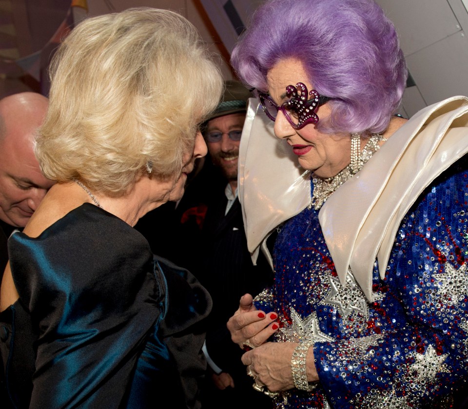 The then Duchess of Cornwall speaks with Australian comedian Barry Humphries in his alter ego as Dame Edna Everage during the Royal Variety Performance in 2013