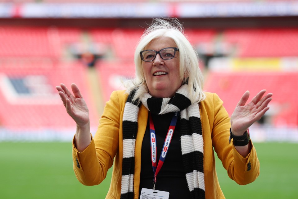 Carol Shanahan, co-owner of Port Vale, applauds after a victory at Wembley Stadium.