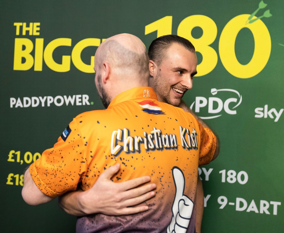 Kist and Chris shared an embrace after the darts fan was presented with his Christmas bonus