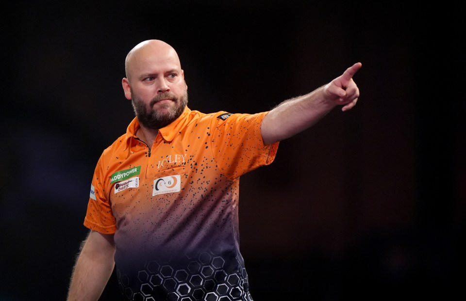 Christian Kist celebrates during a darts match.