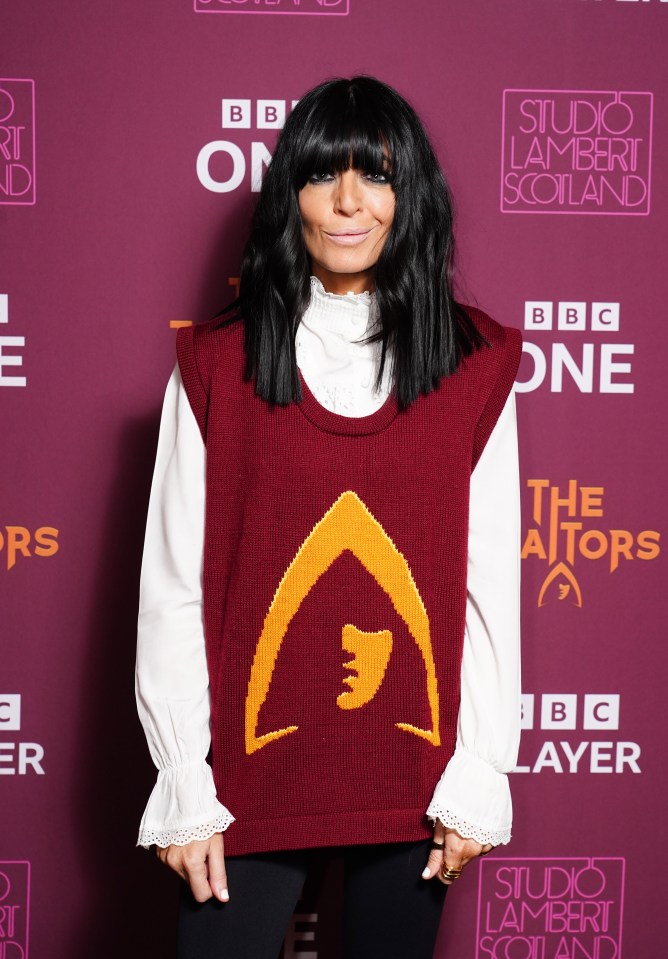 Claudia Winkleman wearing a sweater featuring the logo from The Traitors in London