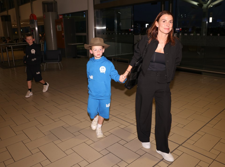 Coleen Rooney has been seen leaving Australia with her two youngest sons by her side