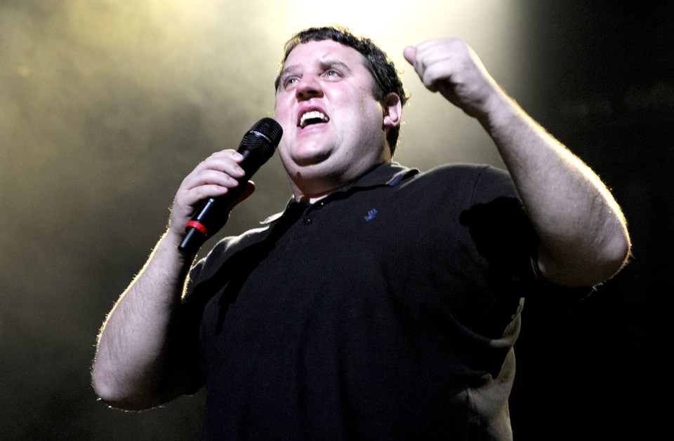 Comedian Peter Kay performing on stage.