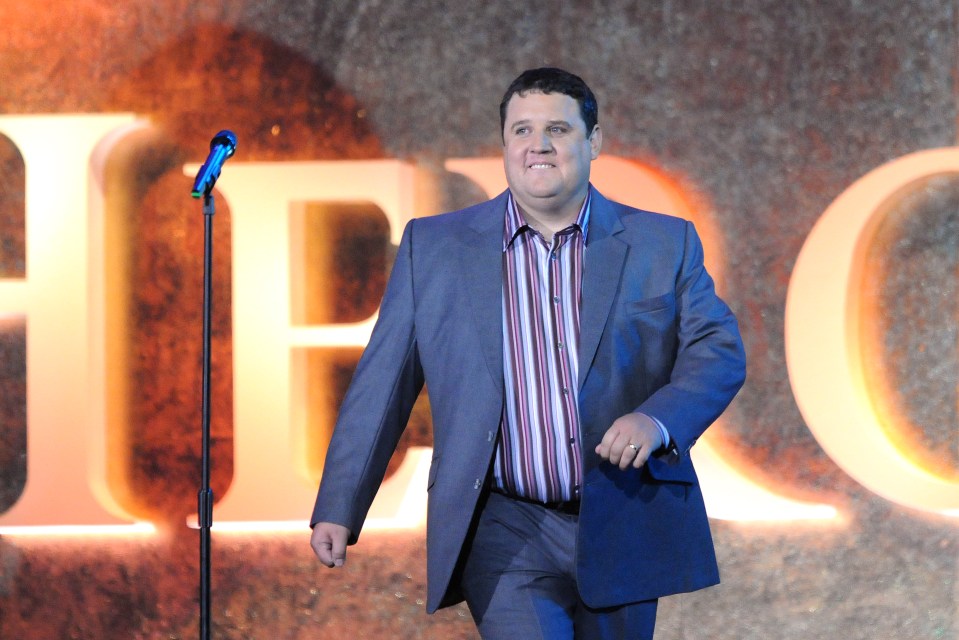 Peter Kay performing live on stage.