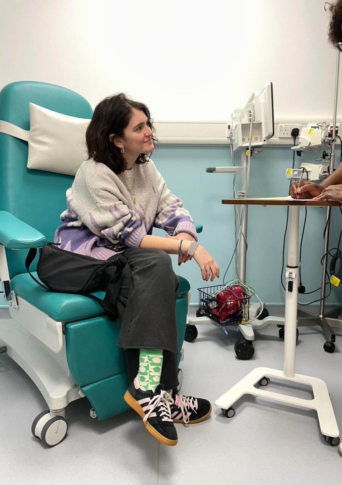 Woman in hospital chair during appointment.