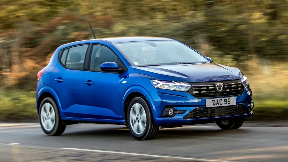 A blue Dacia Sandero driving on a road.