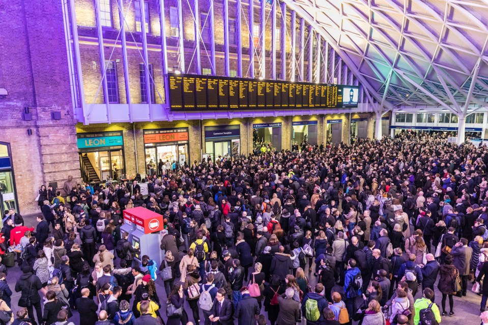 A large crowd of people waiting at Kings Cross station.