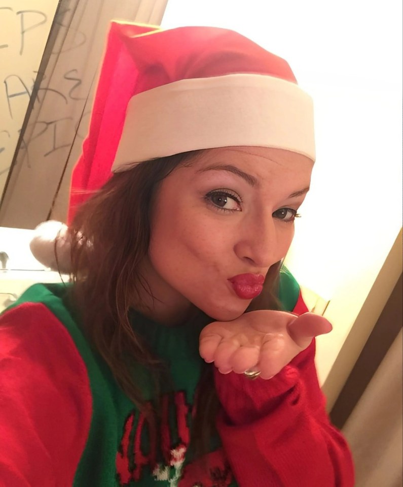 Woman in elf hat blowing a kiss.